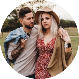 Couple embracing outdoors, dressed in casual attire, ready for an Icelandic adventure.