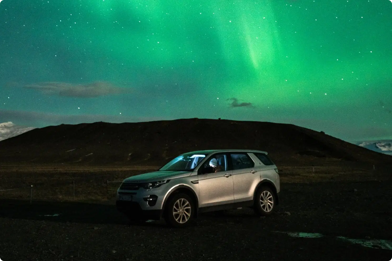 A car driving on an Icelandic road.