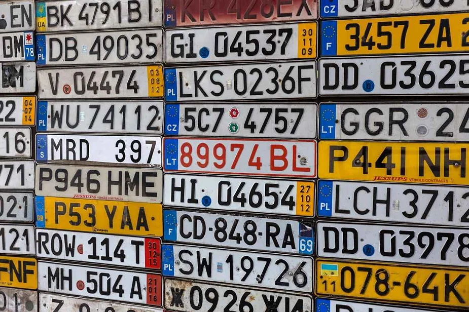 A collage of various car license plates from different countries, showcasing a variety of designs, numbers, and letters.