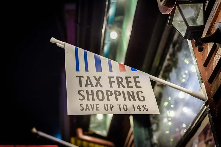 A close-up view of a tax-free shopping sign hanging outside a store in Reykjavik, Iceland, promoting savings of up to 14%.