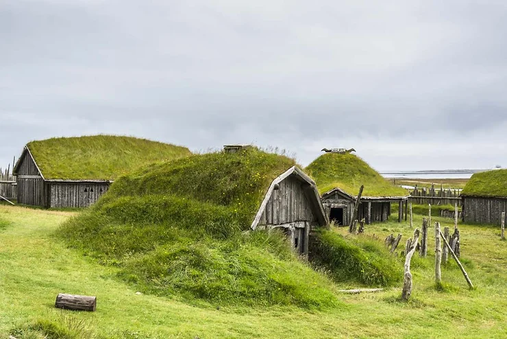 Traditional Icelandic turf houses with grass-covered roofs, illustrating the historical Viking lifestyle in Iceland.