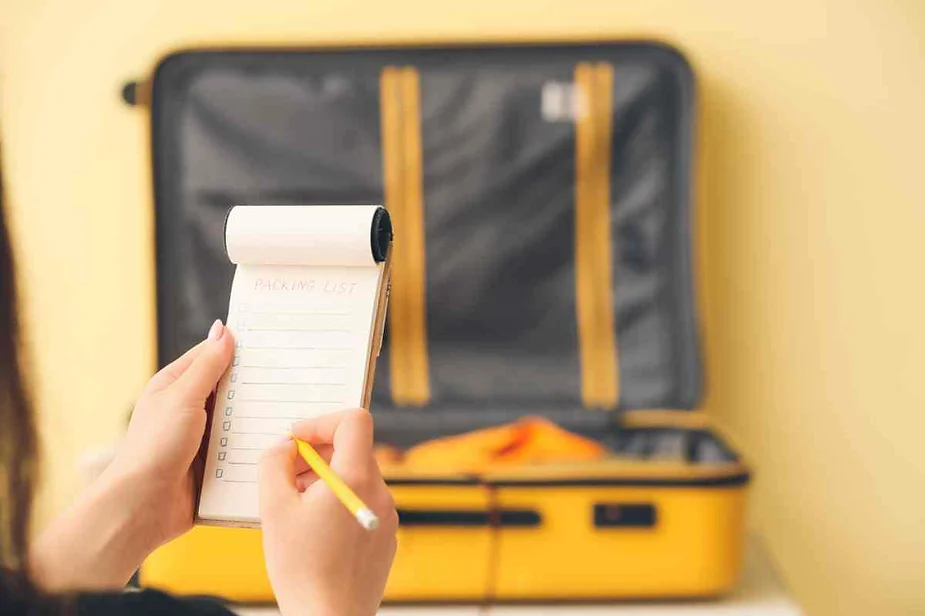 A close-up image of a person holding a small notepad with a 