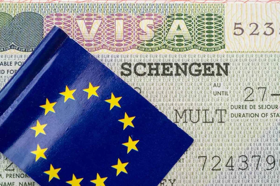 A Schengen visa document with the word 