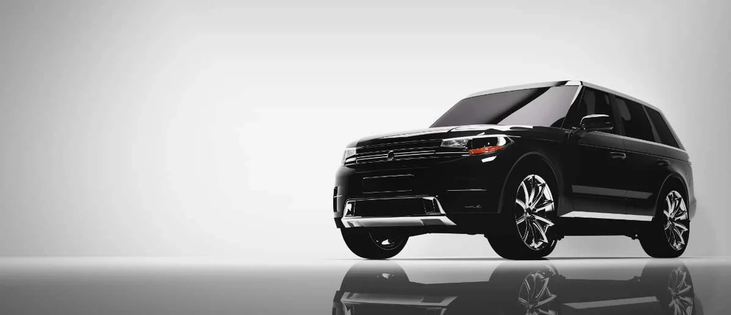 A sleek, black luxury SUV with tinted windows, displayed in a modern, minimalistic setting with a reflective floor. The SUV's design features bold lines and chrome accents, emphasizing its upscale appearance. The image captures the vehicle from a low angle, highlighting its robust and stylish presence.