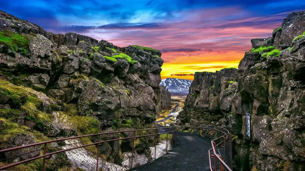 Aerial view of Thingvellir National Park in Iceland, highlighting the expansive Almannagjá fault with autumn-colored vegetation covering the surrounding landscape.