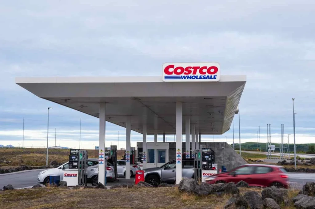 Costco Wholesale gas station in Iceland with cars refueling under a cloudy sky, highlighting the convenience and accessibility of the brand