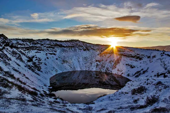 Top views of kerid crater covered in snow during dusk