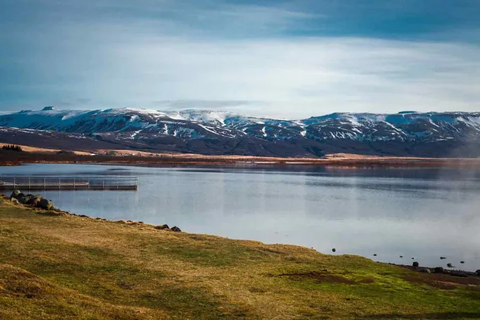 Lake Laugarvatn with snow covered mountains at the back