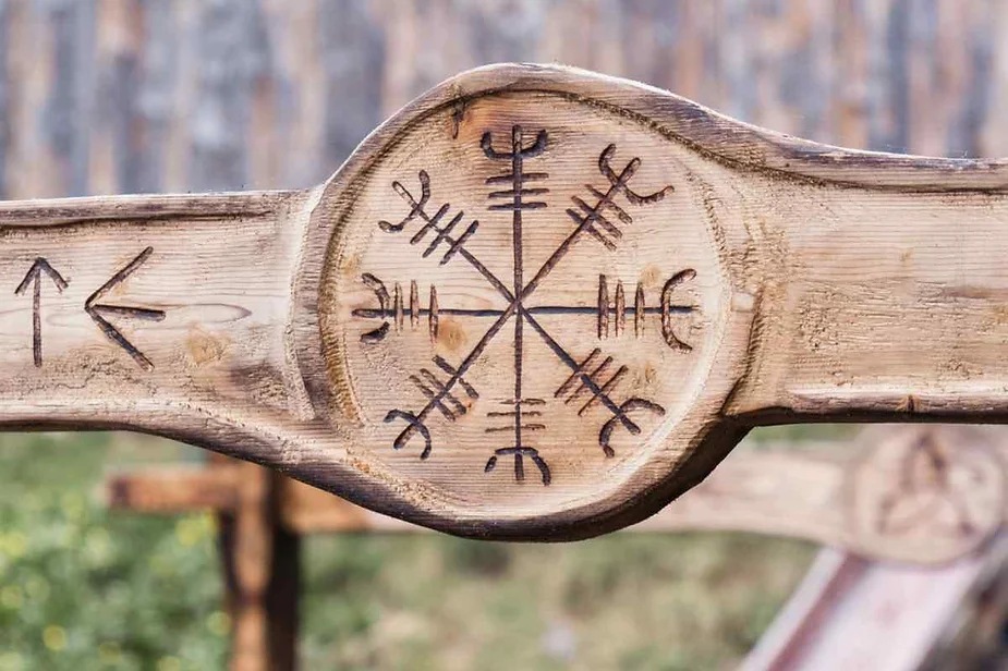 Carved wooden Vegvisir symbol on an ancient Viking artifact, representing guidance and protection in Norse culture.