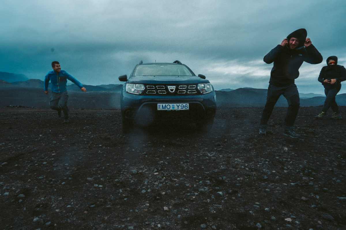 Tourists running from the hard blowing wind in Iceland