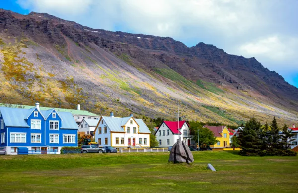 Colorful houses in the scenic town of Isafjordur, Iceland, with a mountainous backdrop.