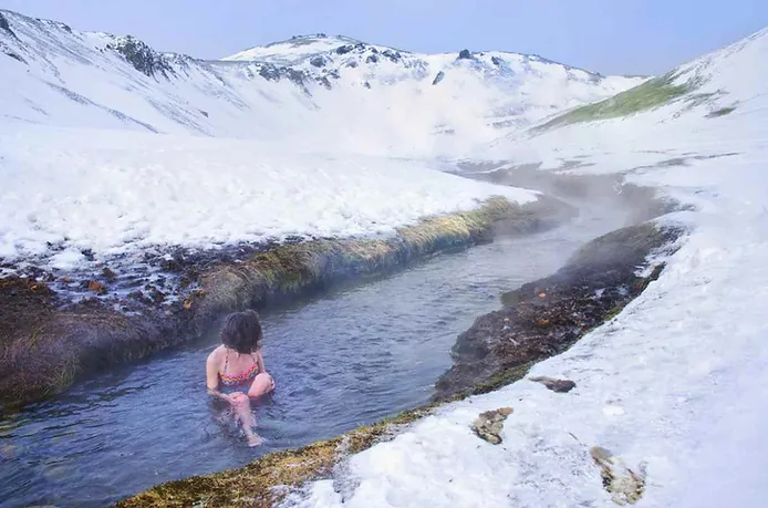 woman enjoying reykjadalur in winter