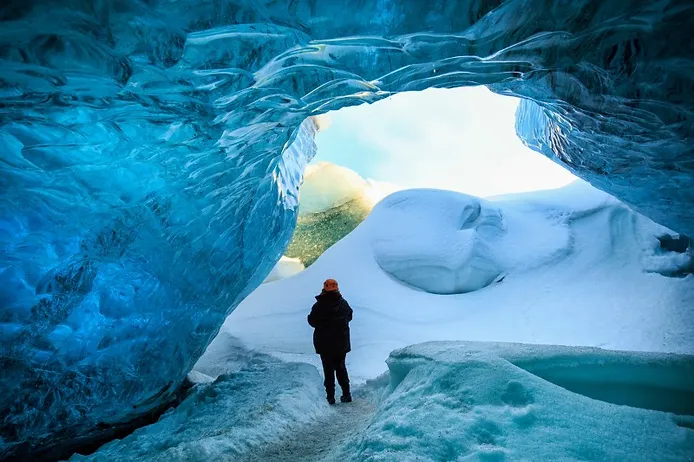 Tourist visiting an Iceland glacier cave