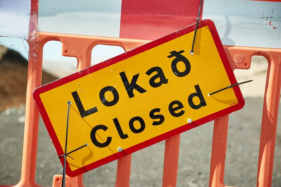 A bright yellow road sign with the Icelandic word 