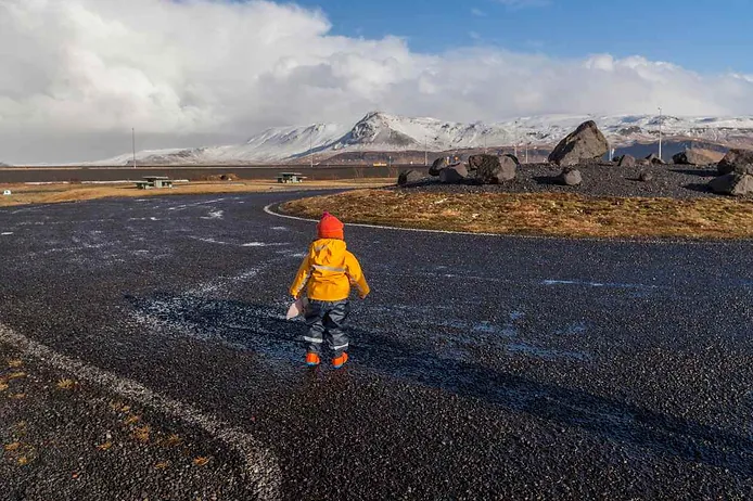 Iceland itinerary with toddler standing on a lava field