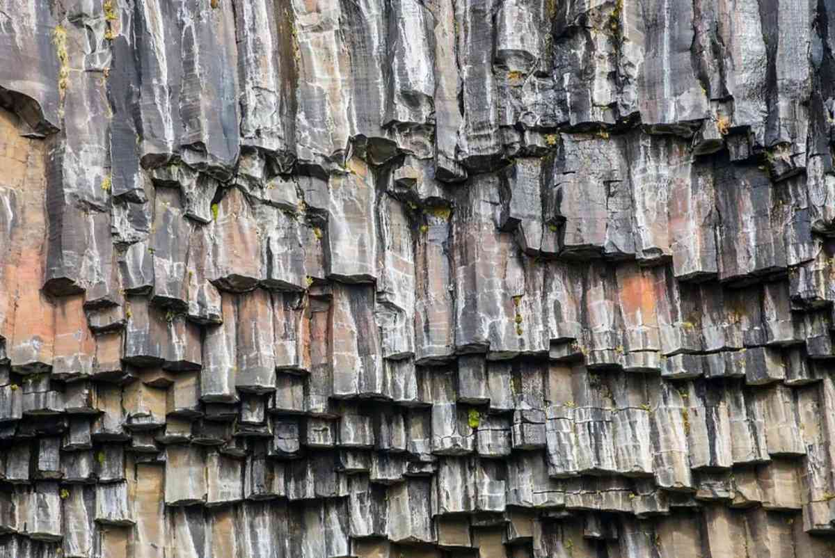 Close-up of unique basalt columns at Svartifoss waterfall in Iceland, showcasing natural geometric formations with varying shades of grey and brown