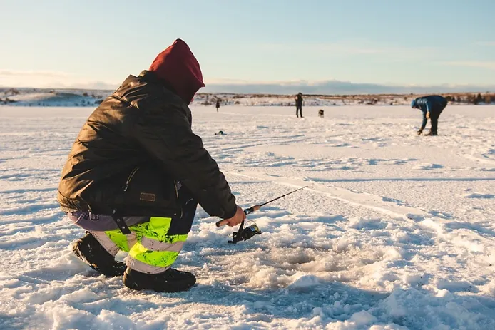 people practising ice fishing in Iceland