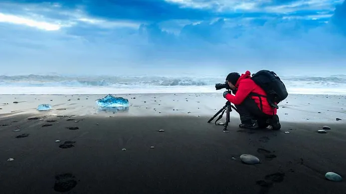 Photographer taking pictures of icebergs