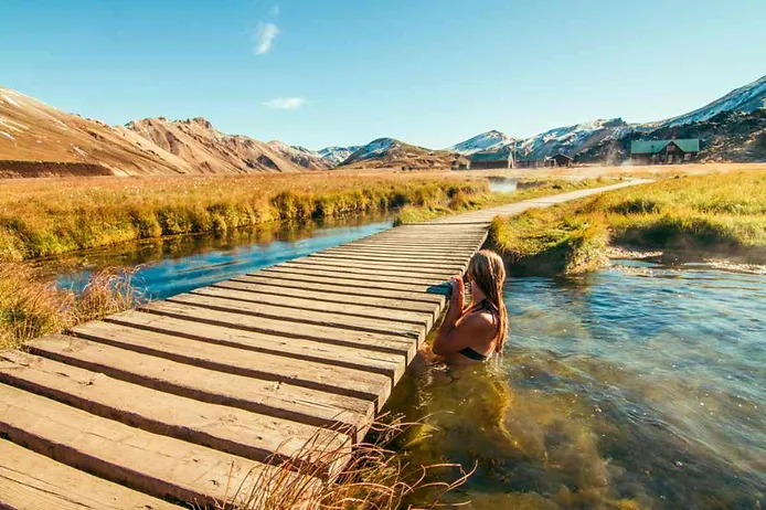 Tourist enjoying Landmannalaugar hot springs