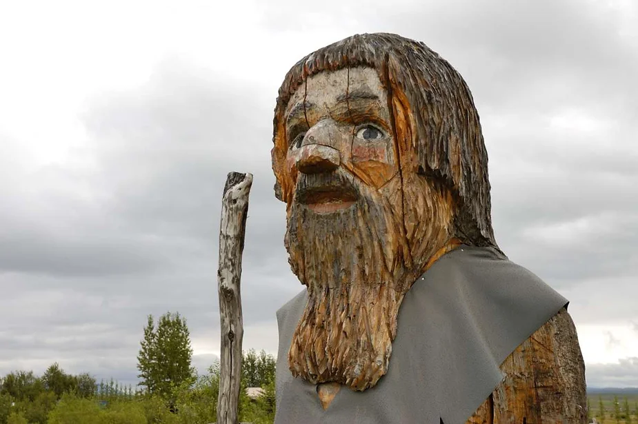 Close-up of a wooden sculpture depicting a Norse figure with a bearded face and traditional attire, showcasing Icelandic folk art