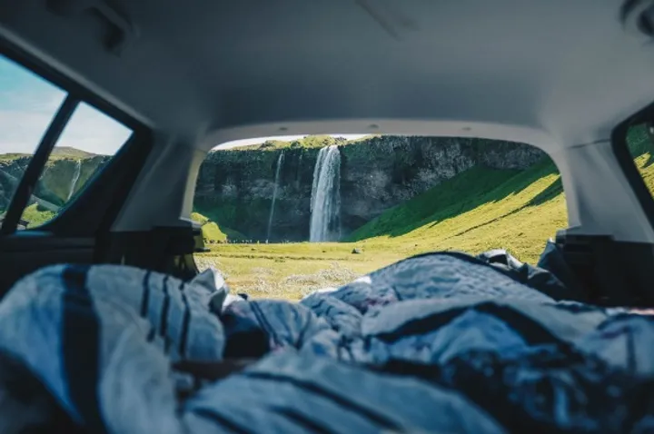 Back of a camper with a view of a waterfall