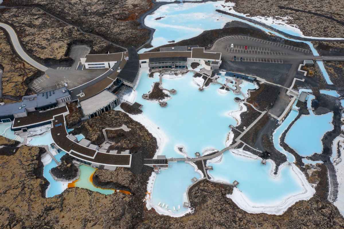 Blue Lagoon with blue geothermal waters surrounded by a black lava field in Iceland.