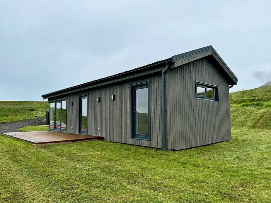 Kaldrananes House near Vik, Iceland, a modern countryside retreat with sweeping views of lush valleys and close proximity to Reynisfjara Black Beach.