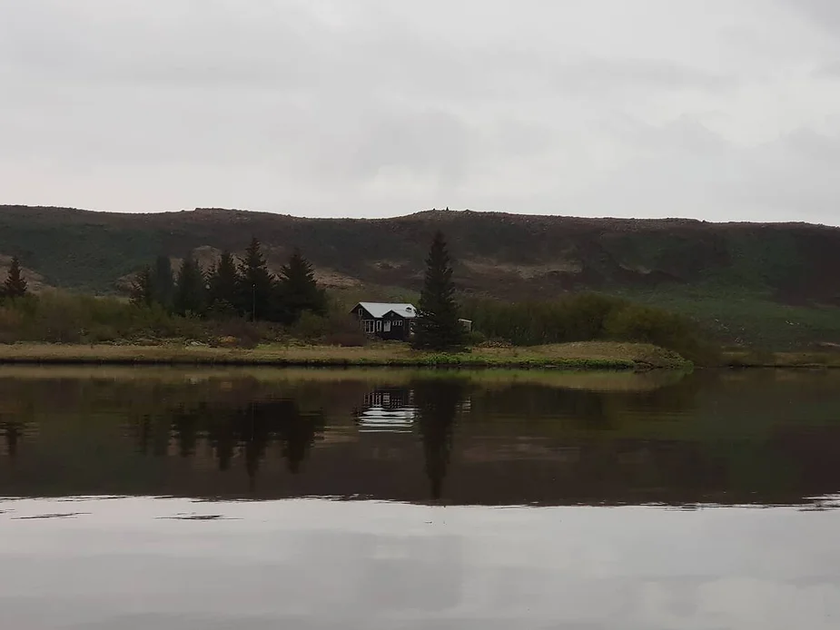 Maríulundur eco-friendly cabin near Reykjavik, Iceland, situated by a private lake with serene mountain and water views.