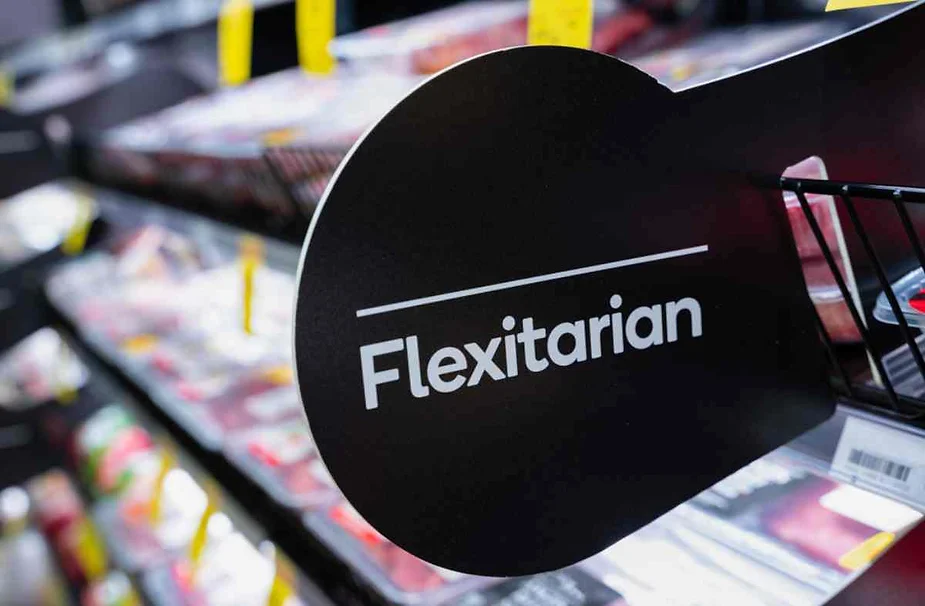 Close-up of a supermarket sign reading 'Flexitarian' near a refrigerated section, reflecting dietary and sustainable food choices in Iceland.