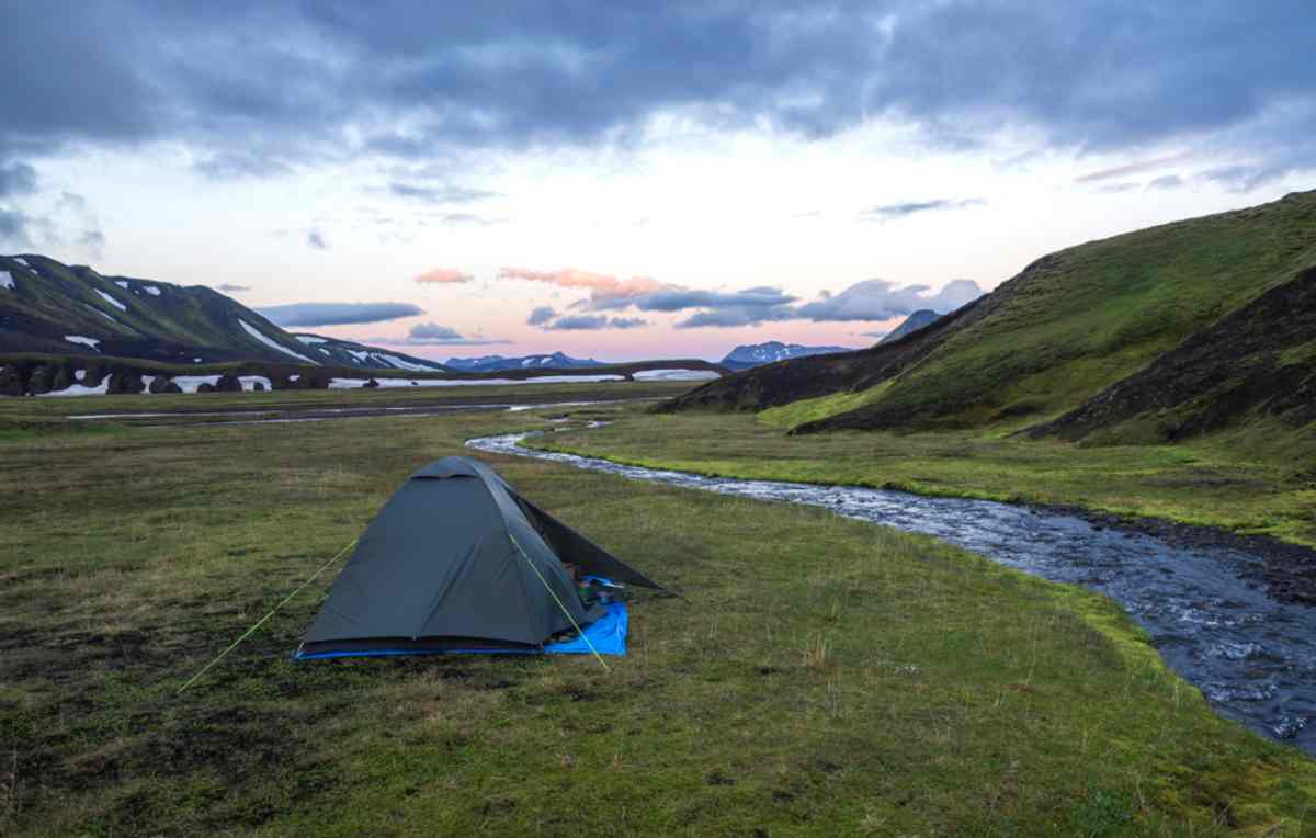 Tent by a stream int he highlands of Iceland