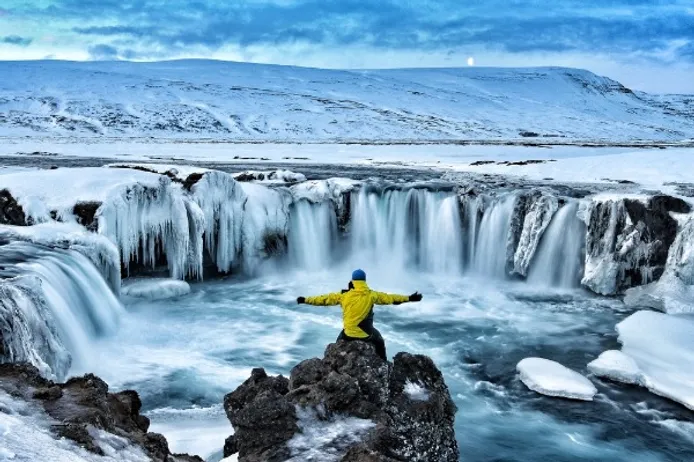 A man enjoying the impressive waterfalls of Iceland