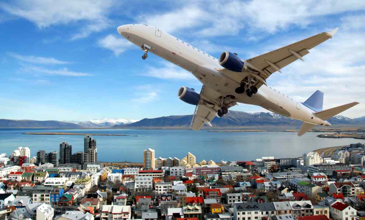 Domestic flights in Iceland with a plane flying over Reykjavik