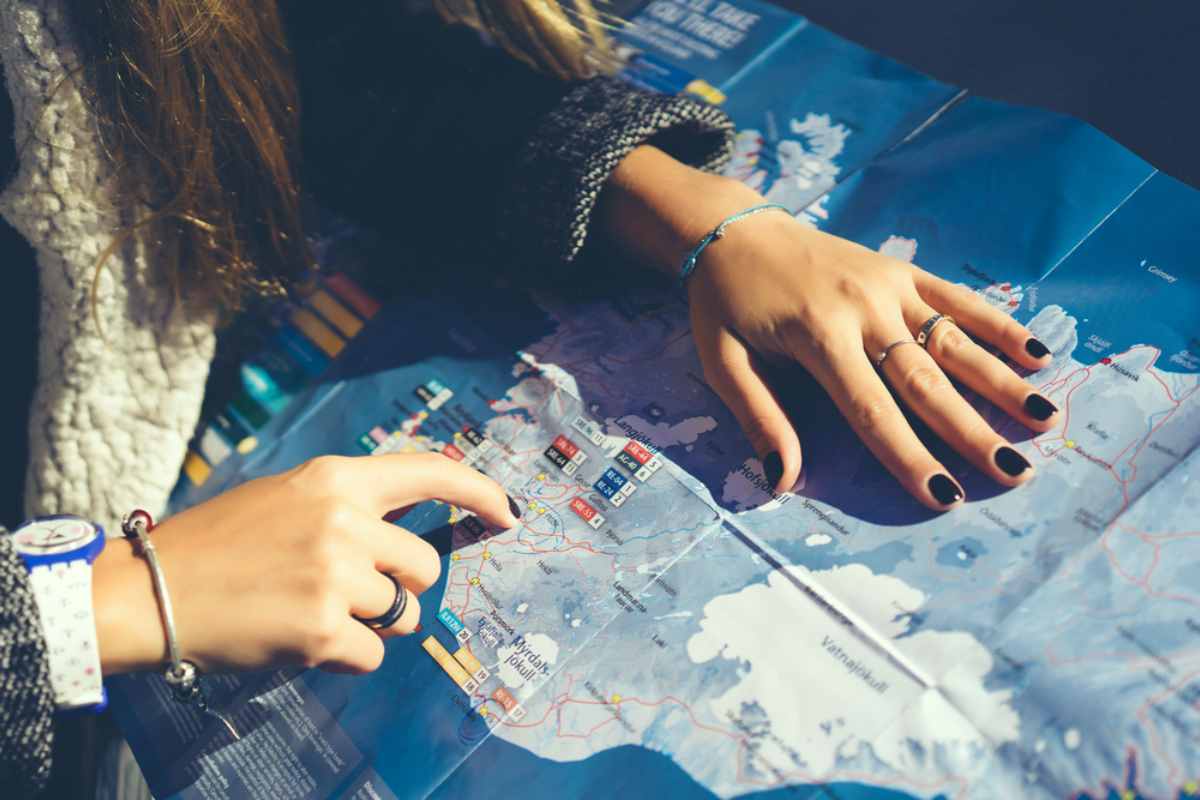 woman pointing a route on her road maps of Iceland