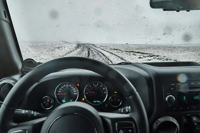 Views of a snow-covered road from the driver's side