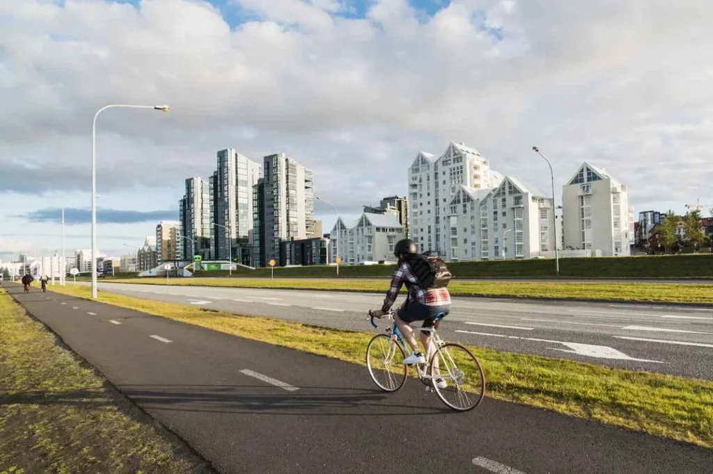 A cyclist rides along a designated bike path in Reykjavík, Iceland.