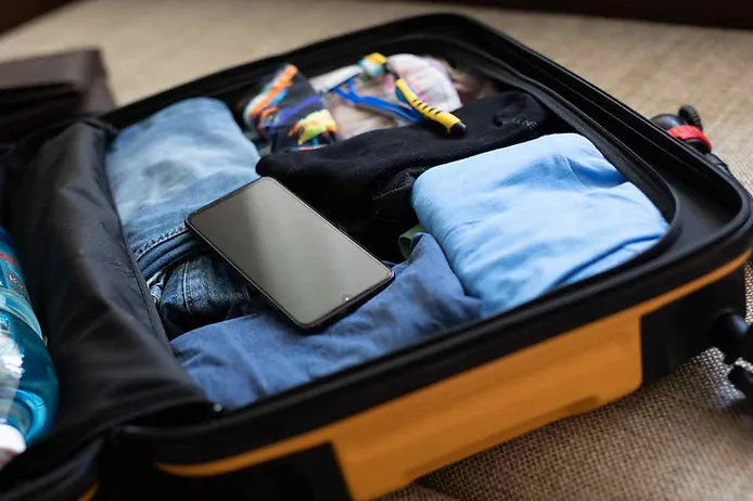 Yellow suitcase with personal belongings for a trip